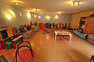 a living room with a couch and a table and chairs at Apartment 13 - Ferienresidenz Roseneck, mit Schwimmbad in Todtnauberg bei Feldberg in Todtnauberg