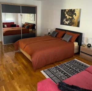 a large bedroom with two beds and a rug at Taya in Mostar