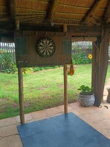 a board with a dartboard on top of a patio at Clyde's on Dale Guest House in Springs