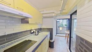 a kitchen with a sink and a counter top at Habyt Bridges - 6-8 Wa In Fong Street in Hong Kong