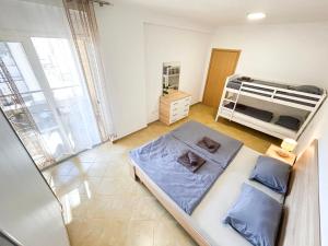 a bedroom with a bed and a bunk bed at Vista 688 in Durrës