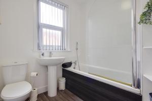 a bathroom with a toilet and a sink and a shower at Wimbourne Road Apartment 3 in Bournemouth