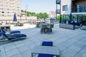 a patio with chairs and tables on a building at 2 Bedroom 2 Bathroom New Apartment Close To Mayo! in Rochester