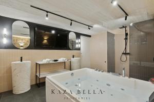 a large bathroom with a tub and a tv at KAZA BELLA - Maisons Alfort 5 Luxurious apartment with private garden and Jacuzzi in Maisons-Alfort