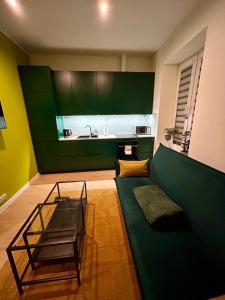 a living room with a green couch and a table at Apartment Targowa L7 in Lublin