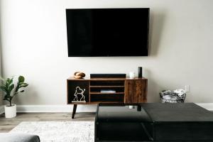 a living room with a tv on a wall at New Luxury Townhome in Youngsville