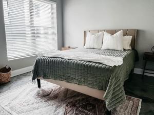 a bedroom with a large bed with a window at New Luxury Townhome in Youngsville