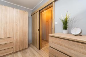 a room with wooden cabinets and a door at Fala 2 by Grand Apartments in Gdańsk