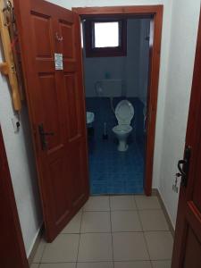 a small bathroom with a toilet and a door at Family Hotel Shisharka in Batak +63 photos