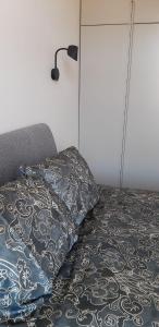 um quarto com uma cama com uma almofada e um candeeiro em Giertmaņa apartamenti em Liepāja