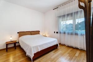 a bedroom with a bed and a large window at Villa azalea in Induno Olona +35 photos