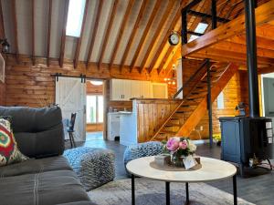 a living room with a couch and a table at Light House in Brackley Beach