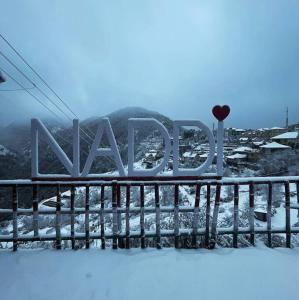 a sign for a ski resort in the snow at Abhi house in McLeod Ganj