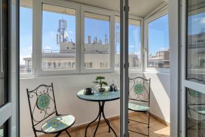 a balcony with a table and chairs and a ship at RDI Elegance Apartment Downtown in Bucharest