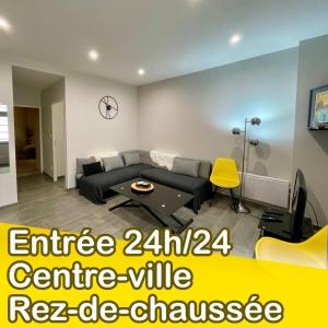 a living room with a couch and a table at « La Bicyclette » 35m2 tout équipé centre ville in Mayenne