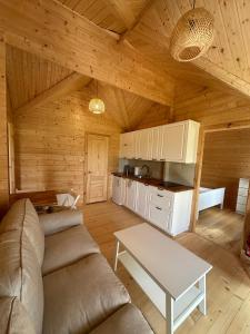 a living room with a couch and a table at DOMKI NAD STAWEM in Kazimierz Dolny