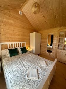 a bedroom with a bed in a wooden cabin at DOMKI NAD STAWEM in Kazimierz Dolny