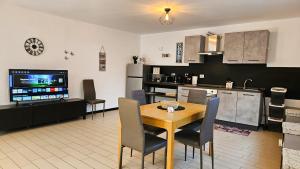 a kitchen and dining room with a table and chairs at AK Homes, a due passi da Orio in Azzano San Paolo