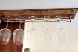 a group of wine glasses hanging from a rack at Red Casa in Seogwipo +26 photos