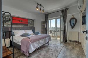a bedroom with a bed and a large window at RDI Elegance Apartment Downtown in Bucharest