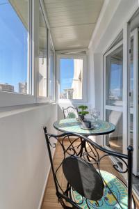 a balcony with a table and chairs and windows at RDI Elegance Apartment Downtown in Bucharest
