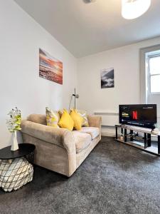 a living room with a couch and a flat screen tv at Penrith in Penrith