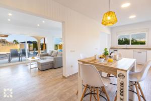 a kitchen and living room with a table and chairs at Villa Socrates by Abahana Villas in Calpe