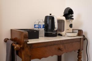 a counter with a coffee maker and water bottles on it at Chalet les Myrtilles in Venthon