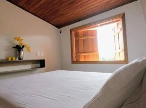 Cama o camas de una habitación en Loft Elegante no coração de Pirenópolis