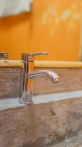 a metal sink faucet on top of a counter at Villa Clarida in Watamu