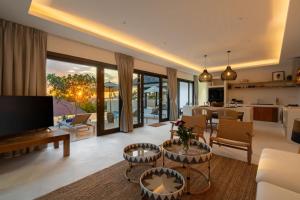 a living room with a couch and a table at VIlla Tramonto sunset seaview villa Koh Samui in Koh Samui