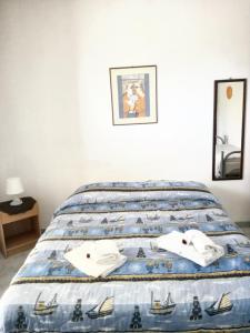 a bed with two white towels on top of it at Studio with sea view furnished balcony and wifi at Marsala 1 km away from the beach in Marsala