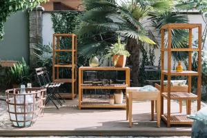 a group of wooden furniture in a patio at Casa da Pedra Cavalgada in Braga