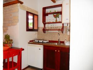 a small kitchen with a sink and a table at Apartments Picasso Komiza in Komiža +105 photos