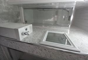 a microwave sitting on top of a counter at Beautiful 5-Bed House in Dagenham newly Renovated in Dagenham