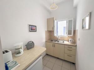 a kitchen with a sink and a counter top at Pension Barbara in Katapola