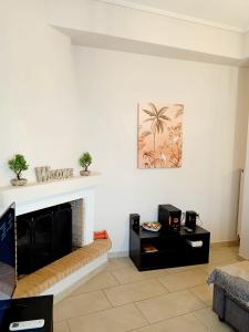a living room with a fireplace and a table at Myilios Leisure Piraeus by Ilios Company in Piraeus