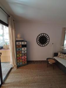 a bedroom with a dresser and a clock on the wall at Appartment mit Charme am Strand in La Pared