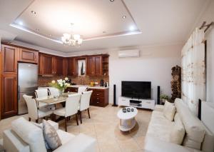 a large living room with a table and a kitchen at Elvira’s House in Lefkada