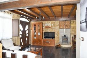 a living room with a television and a fireplace at 4 bedrooms house with sea view enclosed garden and wifi at Cambados Pontevedra 1 km away from the beach in Cambados