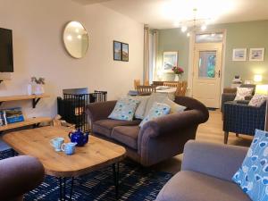 a living room with two couches and a table at Laurel Bank House in Penrith