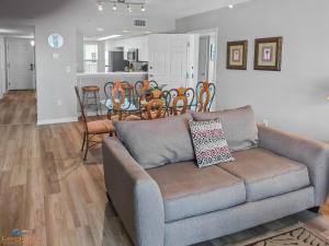 a living room with a couch and a table with chairs at SC 601 - Beachfront Condo With Amazing Views! in Fort Walton Beach