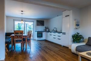 a kitchen and dining room with a table and a dining room at Ferienhaus am Staufeneck in Piding +21 photos