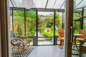 a room with glass doors and chairs and a table at Ferienhaus am Staufeneck in Piding
