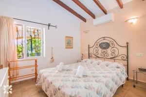 a bedroom with a bed and a window at Villa Serenidad by Abahana Villas in Benissa