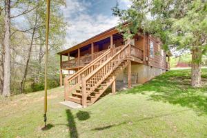 una casa grande con una escalera de madera que conduce a ella en Cozy Cabin with Grill and Fire Pit By Dale Hollow Lake en Frogue