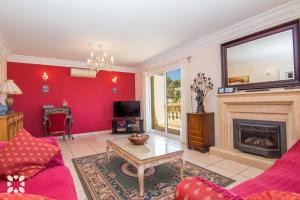 a living room with red walls and a fireplace at Villa Serenidad by Abahana Villas in Benissa