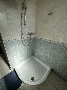 a bathroom with a shower with a toilet in it at Maison de campagne 5 min A20 in Brive-la-Gaillarde +6 photos