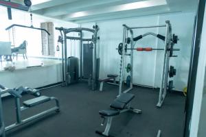 a gym with several tread machines in a room at Kitengule Apartment 001 in Dar es Salaam