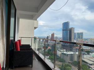a balcony with chairs and a view of a city at Kitengule Apartment 001 in Dar es Salaam
